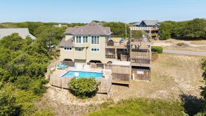 A large house with a swimming pool, multiple decks, and a view of the beach. - New Listing, King Beds, Dogs, Private Pool, Walk to Beach D0109 (Duck)