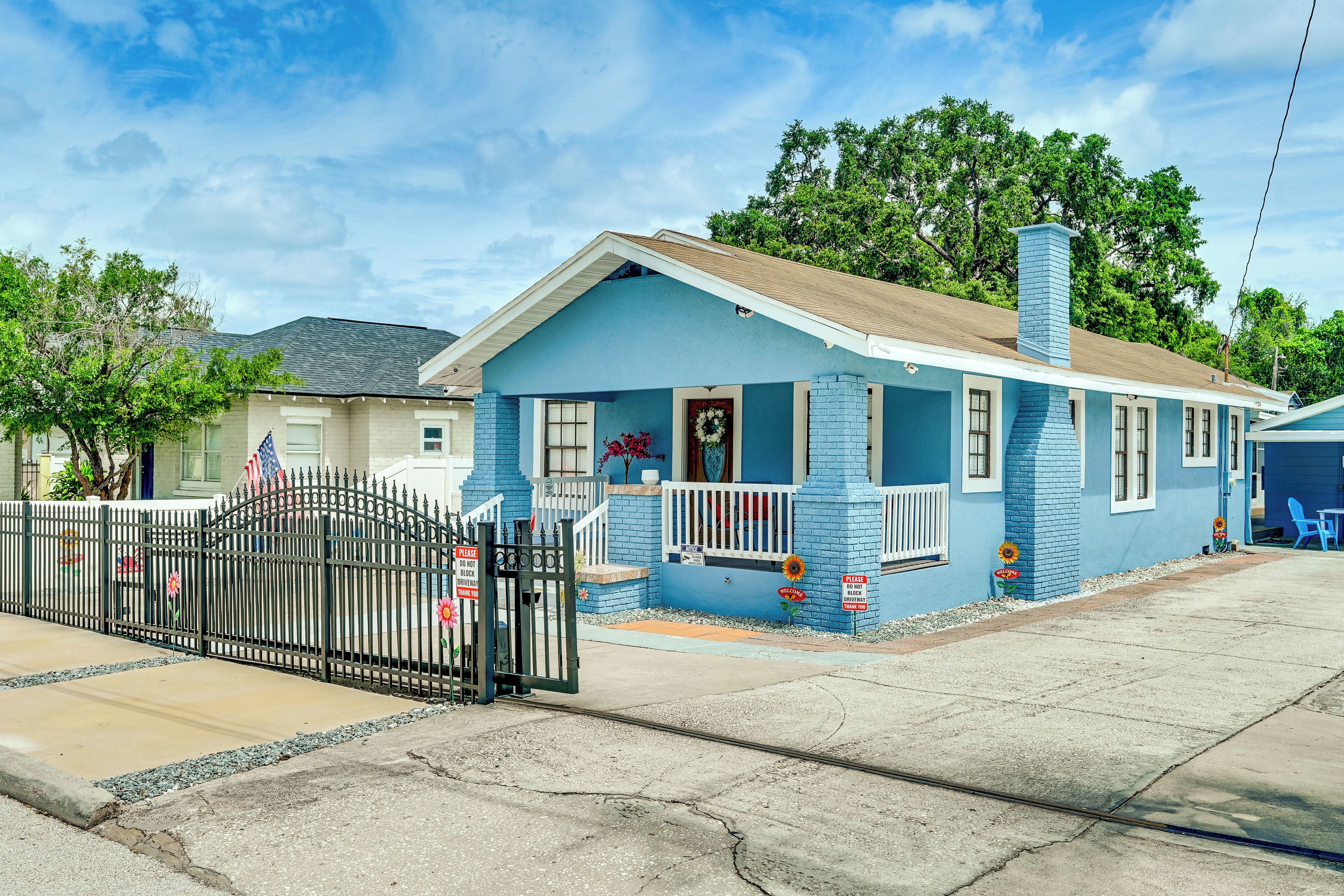 A single-story house with a front porch, a garage, and a small driveway.