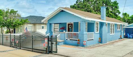 A single-story house with a front porch, a garage, and a small driveway.