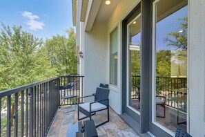 A balcony with a chair, a table, and a railing. - Urban Gem w/ Balcony! Near NRG Stadium & Downtown (Houston)