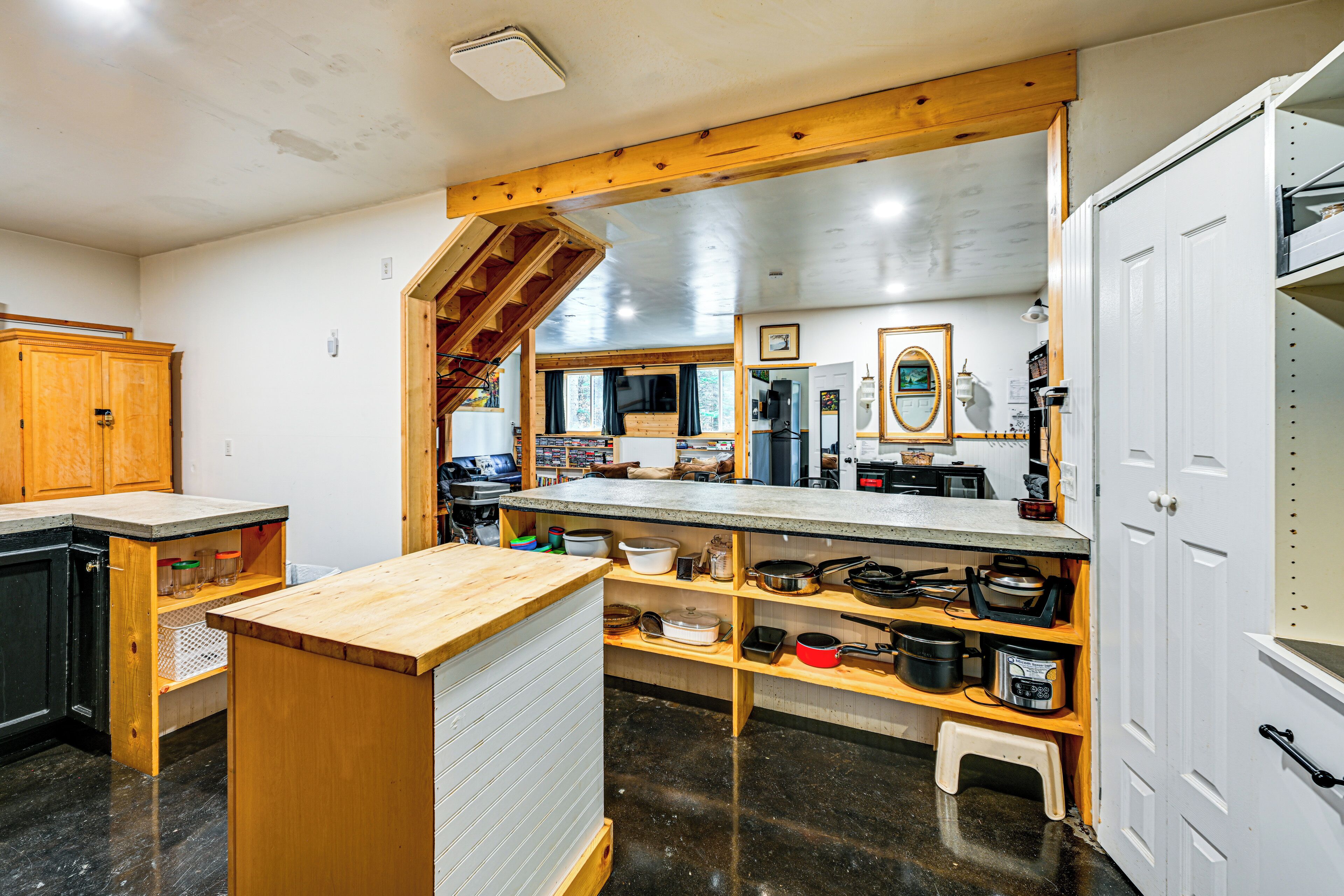 A kitchen with wooden cabinets, a granite countertop, and a built-in oven.