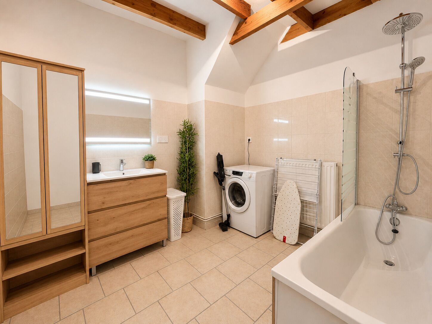 A modern bathroom with a wooden vanity, a washing machine, a drying rack, and a shower.