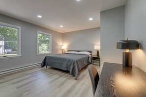 A bedroom with a bed, bedside tables, a desk, and a lamp. - Modern Home Minutes to Mystic, Casinos and Ocean (Groton)