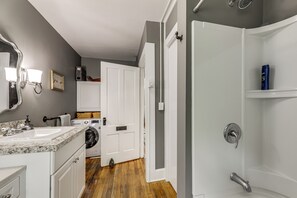 A bathroom with a sink, mirror, and shower. - 2 Mi to Beach & Boardwalk! New London Haven (New London)