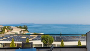 A coastal view with solar panels, a pool, and a clear sky. - Ocean Horizon Apartment Sea View Parking (Vlorë)