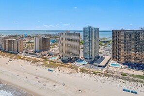 Eine Küstenlandschaft mit Hochhäusern, einem Strand und einer Marina.