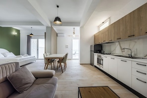 Eine moderne Wohnung mit Wohnbereich, Essbereich und Küche.
