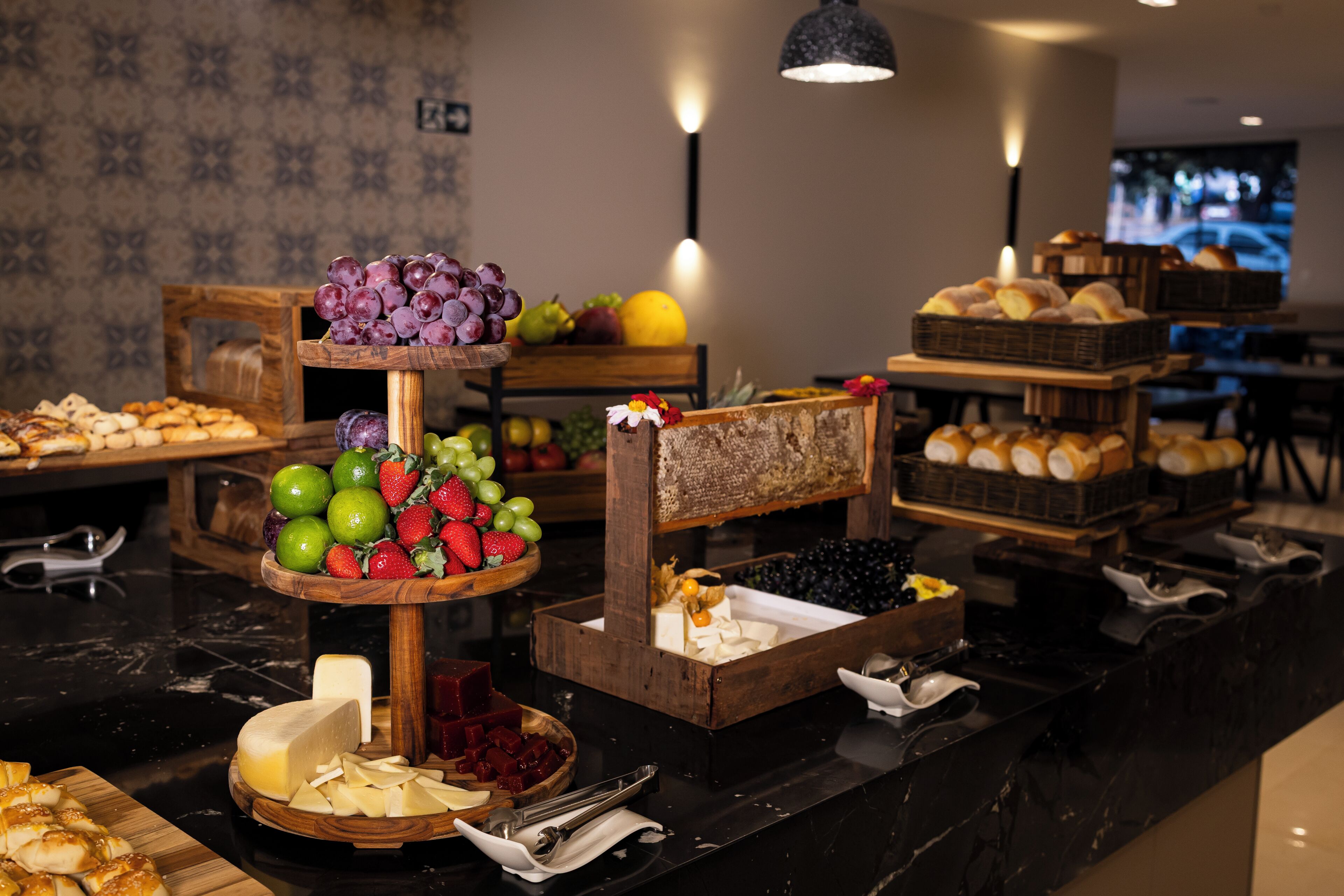 A buffet with various food items and a fruit display.