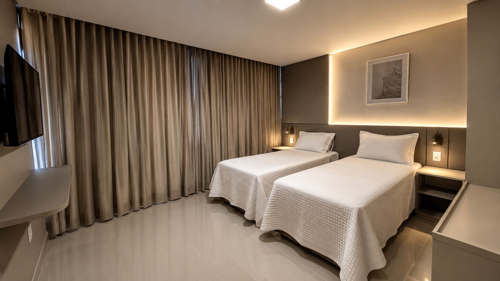 A hotel room with two beds, a TV, a desk, and a large window with curtains.
