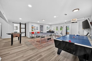 A spacious room with a foosball table, ping pong table, and pool table. - Lakefront with Treehouse, Pool, Gameroom and hottub. 5BR, 4bath (Azle)