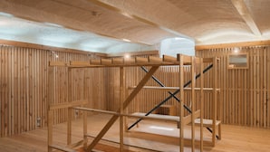 A wooden interior with a bunk bed structure, wooden walls, and a vaulted ceiling. - Aparthotel Hirschenhof (Spital am Semmering)