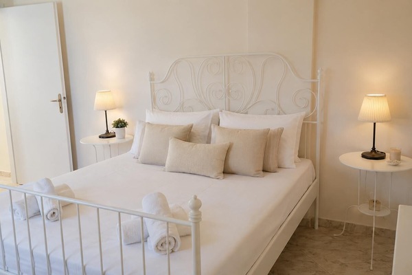 Elegant Bedroom with White Metal Bed and Soft Lighting