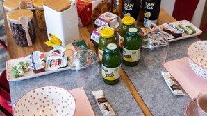 A table with various food items and drinks, including jars, bottles, and packaged goods. - The Key Of Bergamo.Fronte Mura is an elegant apartment located on Via Pignolo (Bergamo)