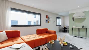 Apartment, City View | Living area | 121-cm Smart TV with digital channels, pay movies
