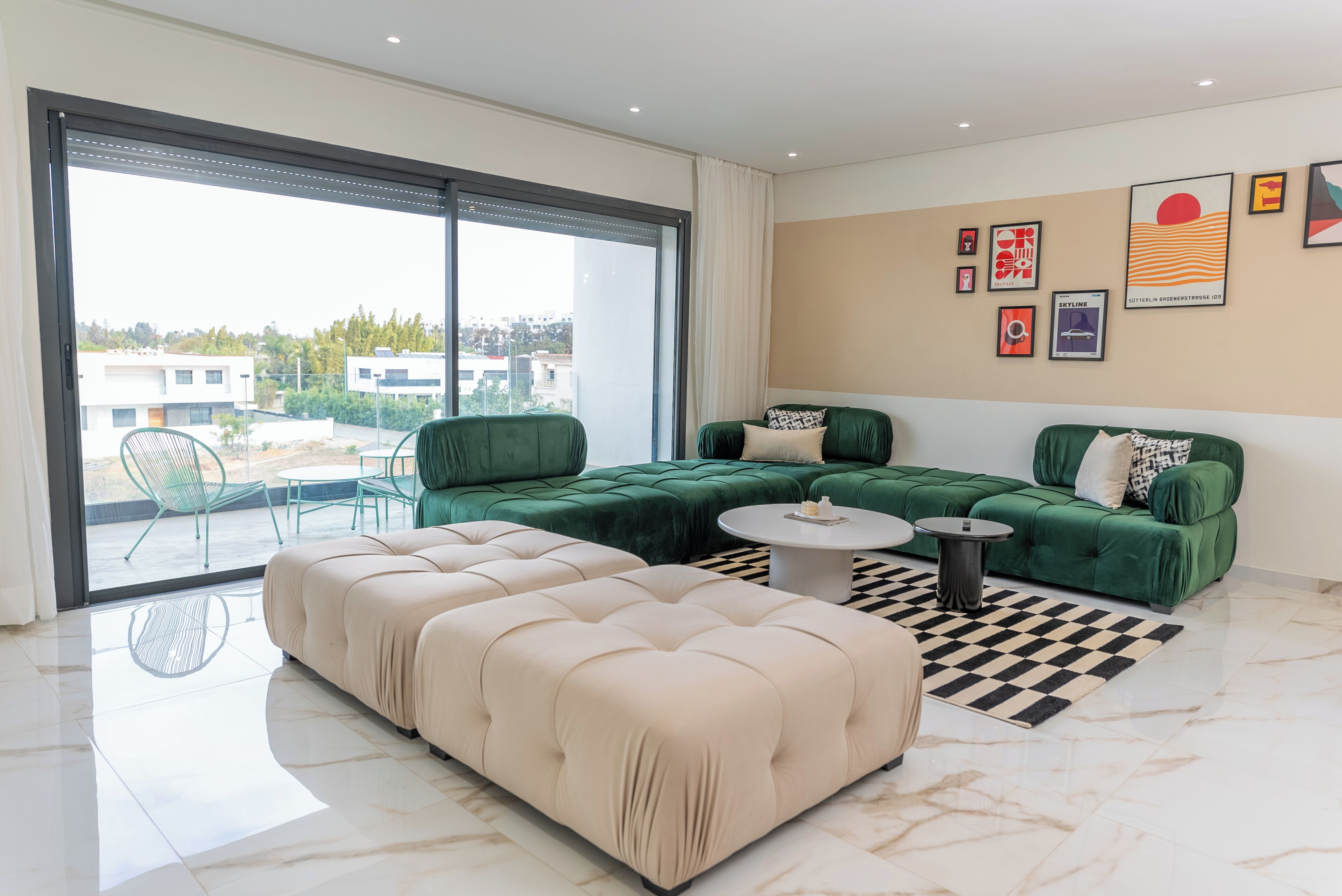 A modern living room with a sectional sofa, a round coffee table, and a large sliding glass door leading to an outdoor area.