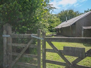 A rustic wooden gate leading to a campsite with a tented accommodation structure. - 3 Bed in Arley (oc-s42696) (Pound Green)