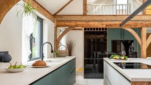 A modern kitchen with a central island, a built-in oven, and a view into the dining area. - 3 Bed in Ditchingham (oc-s42751) (Ditchingham)