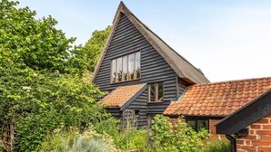 A traditional house with a steeply pitched roof, multiple windows, and a brick extension. - 3 Bed in Chediston (oc-b43313) (Chediston)