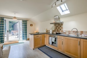 A modern kitchen with a large window, a built-in oven, and a sink. - 2 Bed in Denton (oc-b42753) (Denton)