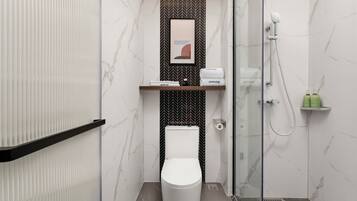 A modern bathroom with a toilet, shower, and marble walls.