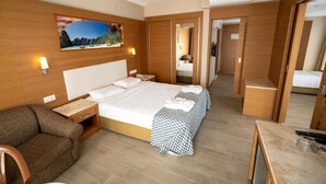 A hotel room with a large bed, a sofa, a desk, and a mirror. - CASA SOLADA CUNDA RESORT & SPA (Ayvalık)