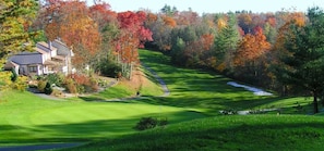 A golf course with a house in the background. - "Teddy's Rest": Cozy Wooded Cottage in Land Harbor with Lake and Pool Access (Newland)