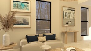 A modern living room with a sofa, coffee table, and artwork on the walls. - Patagon Hotel (El Calafate)