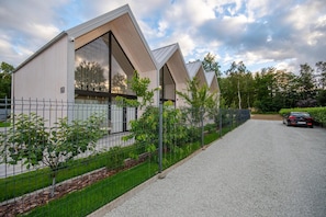 A modern building with a gravel driveway and a car parked in front. - Luxury holiday homes near the beach, Mielno (Mielno)