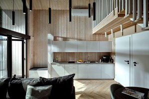 A modern kitchen with white cabinets, a built-in oven, and a coffee machine. - Luxury holiday homes near the beach, Mielno (Mielno)