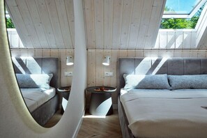 A modern interior with two beds, a round table, and wall-mounted lights. - Luxury holiday homes near the beach, Mielno (Mielno)