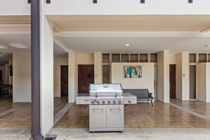 A commercial kitchen with a stainless steel grill, a bench, and a tiled floor. - 10 Luxury Bdrms - Rancho de Sueños - Jaco/Los Sueños - Chef & Driver Included (Playa Herradura)
