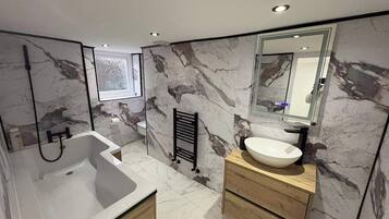 Separate bathtub and shower, deep-soaking bathtub, towels