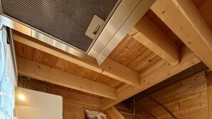 A compact kitchen with a sink, a microwave, and a small refrigerator.