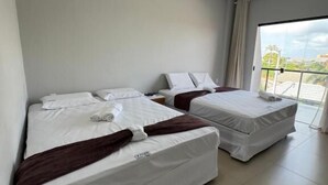 A hotel room with two beds, a large window, and a view of the outside. - Oceane Norte Hotel (Parnaíba)