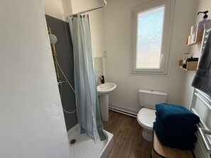 Een douche, handdoeken, toiletpapier