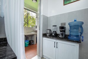 A kitchen with a water dispenser, coffee maker, and a large water jug. - Comfort Suite 2-Bed Apartment in Westlands, next to Mövenpick Nairobi Hotel (Nairobi)