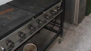 A kitchen area with a stainless steel stove and a refrigerator.
