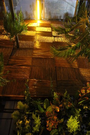 A bamboo floor with a warm light source above.