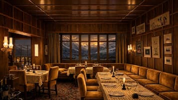 A cozy restaurant with wooden paneling, checkered tablecloths, and framed pictures on the walls.