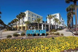 Ein Hotel mit einem Schild, auf dem 'CULEBRA PLACE' steht, umgeben von Palmen und einem Blumenbeet.