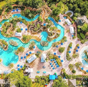 An aerial view of a resort with multiple swimming pools, lounge areas, and tropical landscaping. - Reunion Resort, 12 minutes from Disney Property. Pool, Arcade, Theater sleeps 20 (Kissimmee)