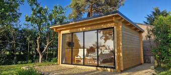 Private, air-conditioned log cabin, with field views, own garden and shower room