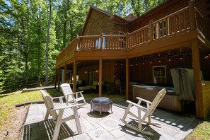 A wooden cabin with a balcony, outdoor seating, and a hot tub. - Big Rock | Theater Room, Hot Tub, Hocking Hills (Rockbridge)