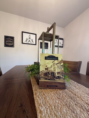 A model of Greenville on a wooden table with framed pictures on the wall behind. - Brand New Townhome, 3 Bed/2.5 Bath Close to Furman, NGU, SRT & Greenville! (Greenville)