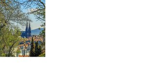 A cityscape with a prominent cathedral and a mountain in the background. - Studio PavinChic, cozy & ideally located (Clermont-Ferrand)
