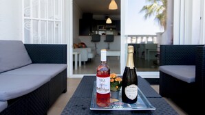A dining table with two bottles of wine and a tray. - WELCS APARTMENT 380 EMP with terrace and parking (Empuriabrava)