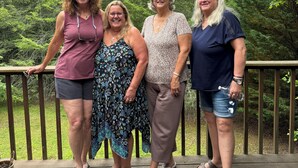 A group of people standing on a wooden deck with a forested background. - 3-bedroom country house in charming Murphy with AC (Murphy)