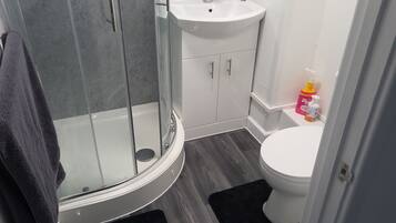 Shower, towels, soap, toilet paper