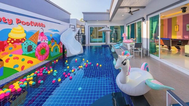 A pool area with colorful balls, a slide, and inflatable toys. - Sunday Villa Green Shawty Pattaya (Bang Lamung)