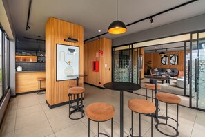 A modern interior with wooden accents, a whiteboard, and a seating area with stools. - 2BR/2BA w/ View · A/C · Pool · 24/7 Doorman (Miraflores)